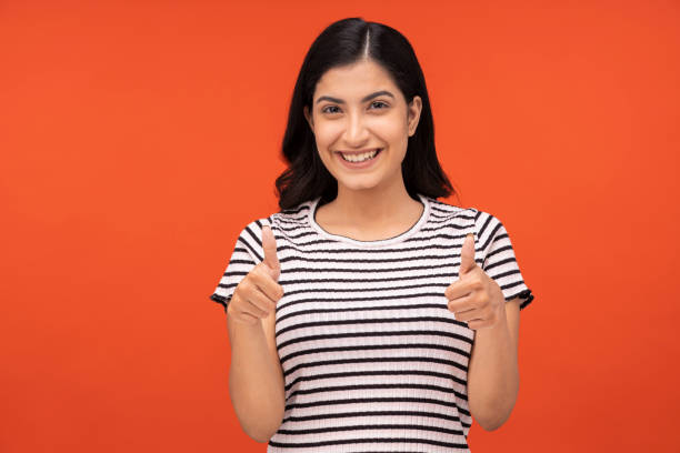 istock young woman on orange background, 1334921386