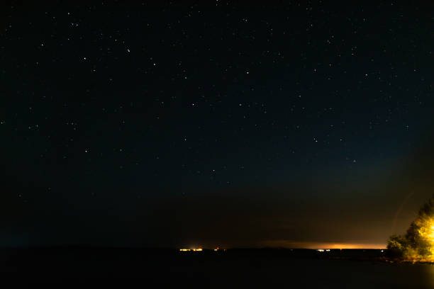istock night starry sky and lights from the city 1334922615