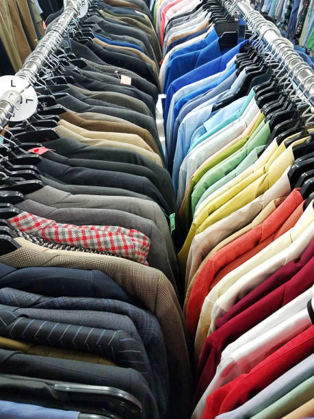 Thrift Shop Suits And Shirts Mens sports jackets and shirts hanging in a thrift store. colorful check shirts on sale at a clothing store stock pictures, royalty-free photos & images