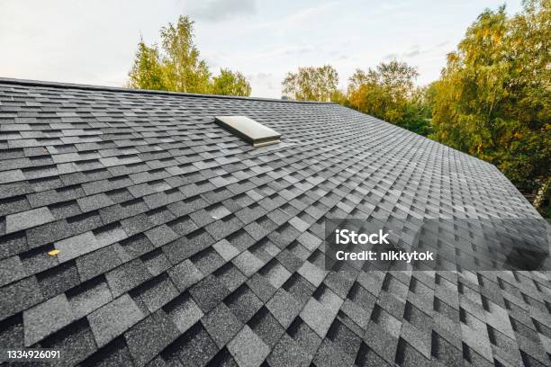 Roof Of New House With Shingles Rooftiles And Ventilation Window Stock Photo - Download Image Now