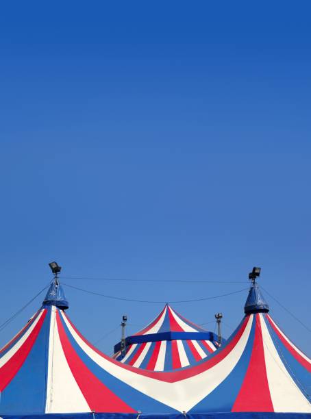 istock Circus tent under blue sky colorful stripes 1334927799
