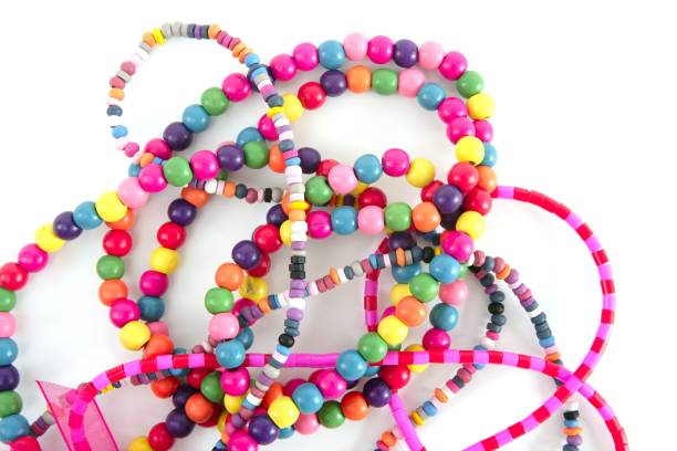 istock Colorful wood necklaces mess over white 1334928394