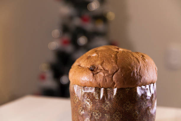 istock Panettone with blurry Christmas lights blinking in the background. 1334928433