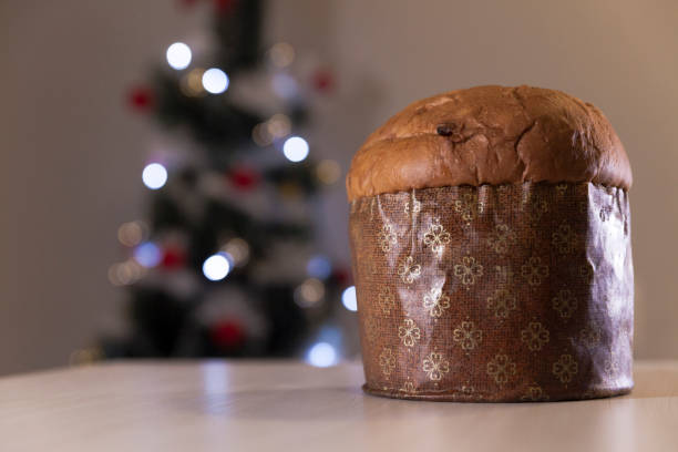 istock Panettone with blurry Christmas lights blinking in the background. 1334928465