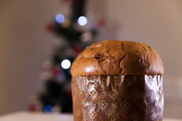 istock Panettone with blurry Christmas lights blinking in the background. 1334928522
