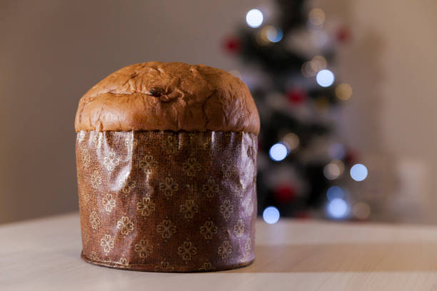 istock Panettone with blurry Christmas lights blinking in the background. 1334928530