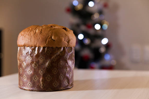 istock Panettone with blurry Christmas lights blinking in the background. 1334928540