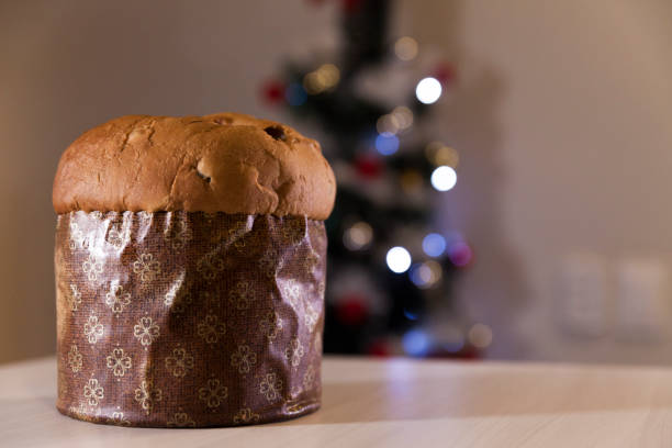 istock Panettone with blurry Christmas lights blinking in the background. 1334928542