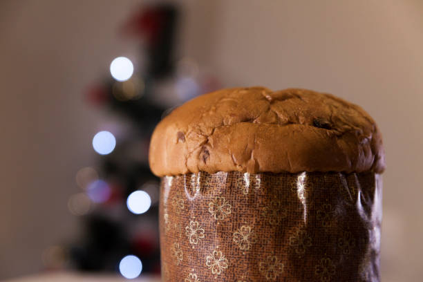 istock Panettone with blurry Christmas lights blinking in the background. 1334928631