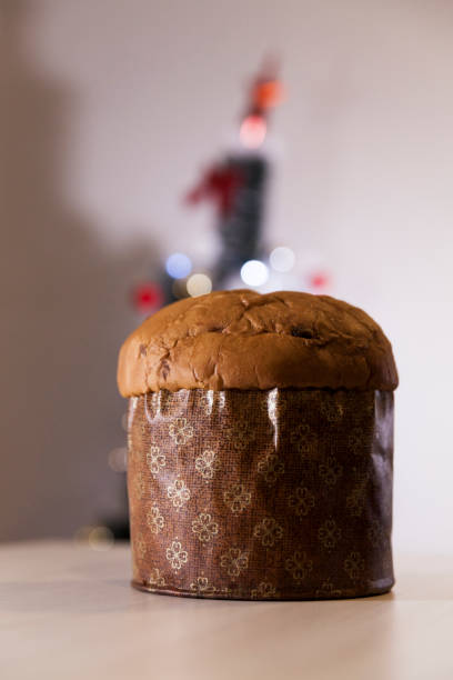 istock Panettone with blurry Christmas lights blinking in the background. 1334928650