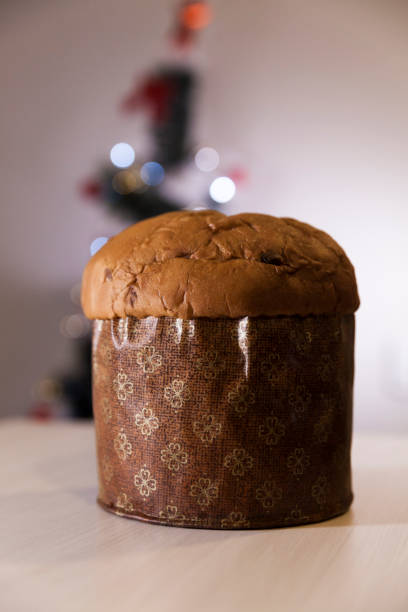 istock Panettone with blurry Christmas lights blinking in the background. 1334928654