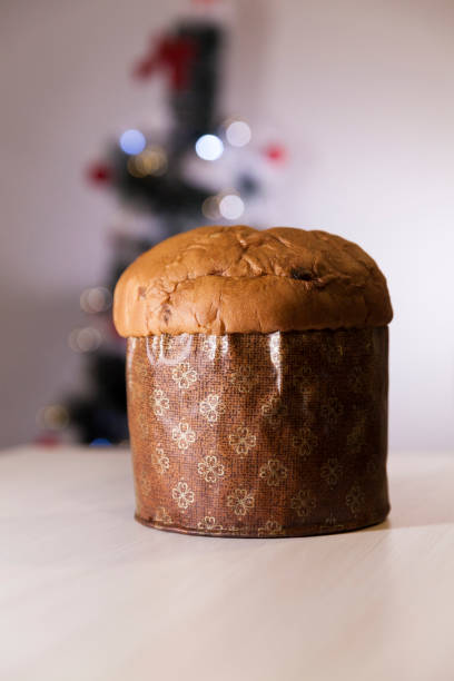 istock Panettone with blurry Christmas lights blinking in the background. 1334928674