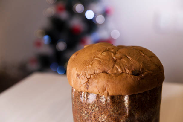 istock Panettone with blurry Christmas lights blinking in the background. 1334928678