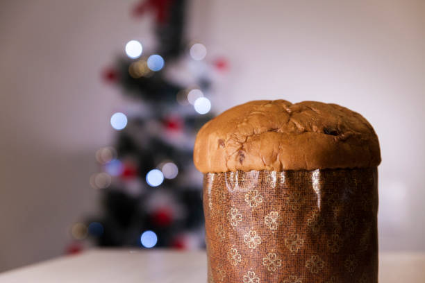 istock Panettone with blurry Christmas lights blinking in the background. 1334928681