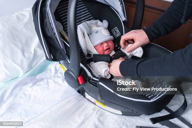 Newborn Being Put In Carseat To Go Home From Hospital Stock Photo - Download Image Now