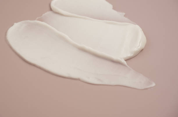 istock White beauty cream lotion highlighter smear swatch smudge on pink background 1334932754