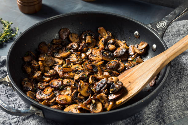 Homemade Healthy Sauteed Mushrooms Homemade Healthy Sauteed Mushrooms with Butter and Thyme sauteed stock pictures, royalty-free photos & images