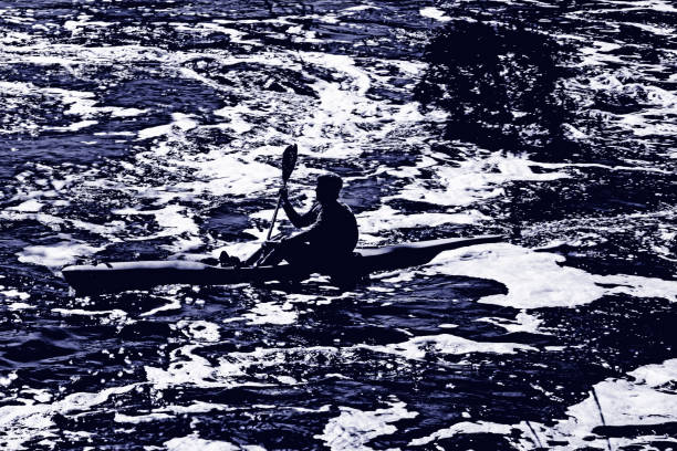 Perth, Wa - Aug 15 2021:Silhouette of unrecognizable person Kayaking over rapids in white waters river.Kayaking is an water official sports. It was started from Germany which announced that kayaking became one of the Olympics sports along with canoeing.