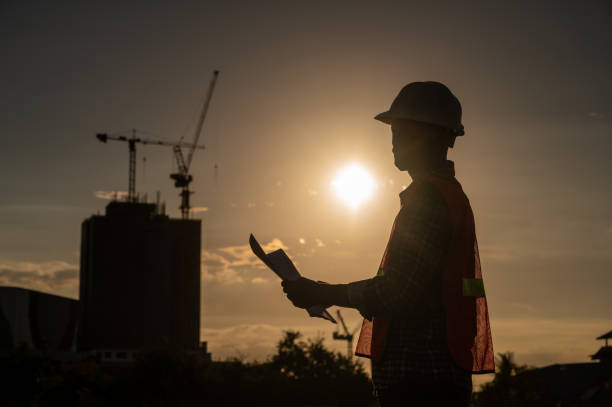 istock male engineer working construction site at Silhouette Sunset time 1334936203