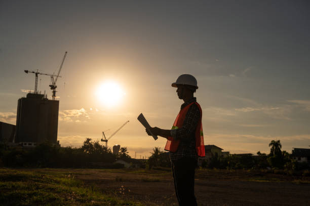 istock male engineer working construction site at Silhouette Sunset time 1334936211