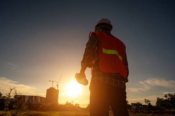istock male engineer working construction site at Silhouette Sunset time 1334936212