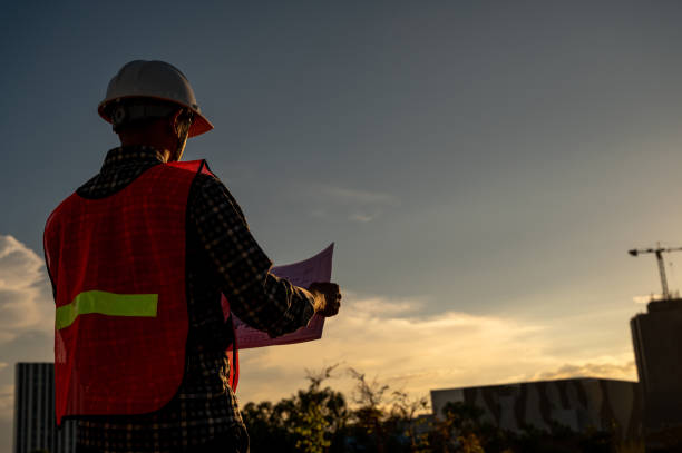 istock male engineer working construction site at Silhouette Sunset time 1334936216