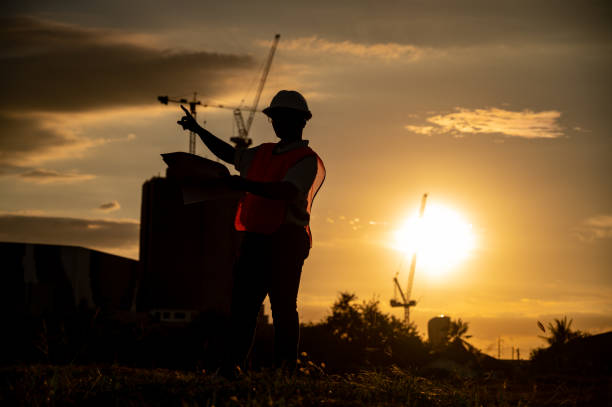 istock male engineer working construction site at Silhouette Sunset time 1334936217
