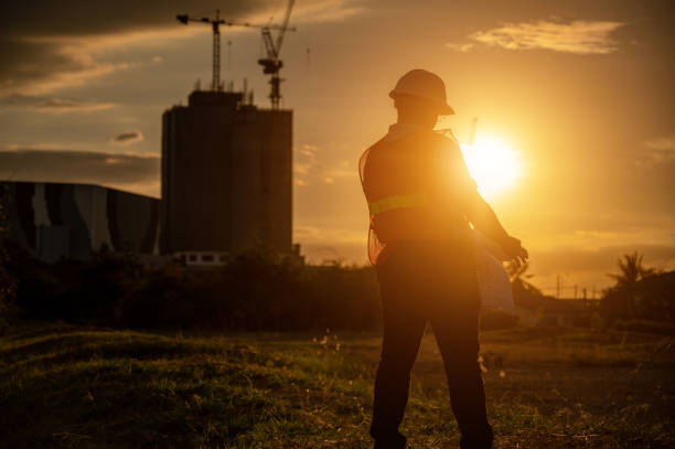 istock male engineer working construction site at Silhouette Sunset time 1334936226