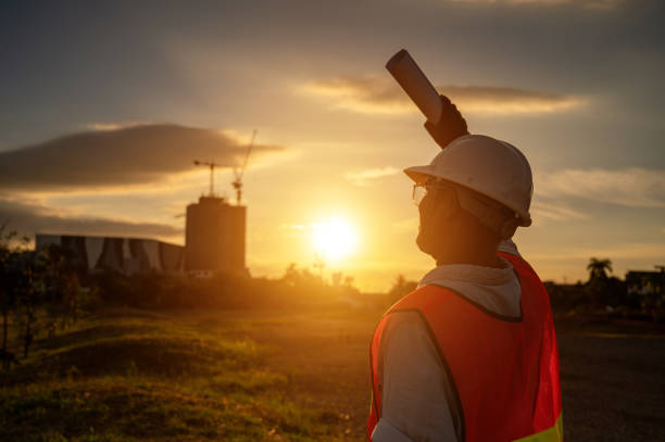 istock male engineer working construction site at Silhouette Sunset time 1334936230