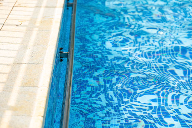 istock edge of a swimming pool in a sunny day 1334941190