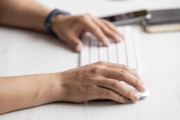 istock typing on a modern keyboard, technology and modernity at work desk, in the background a cell phone, notebook, office objects 1334941213