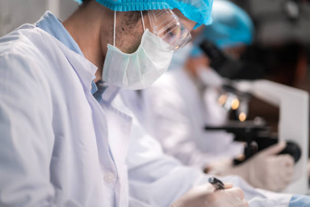 istock Health care researchers working in life science laboratory, medical science technology research work for test a vaccine, coronavirus covid-19 vaccine protection cure treatment 1334945708
