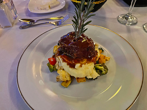 Short rib over mashed potatoes and vegetables.