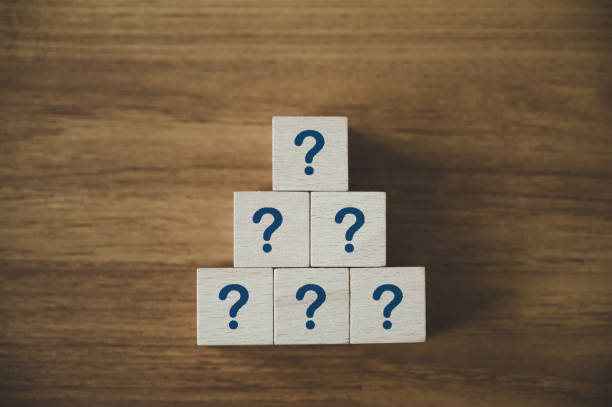 istock Wooden cube block shape stacking with sign question mark symbol on wood table 1334948453