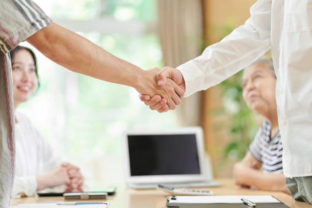 istock Young men and older men shaking hands 1334948460