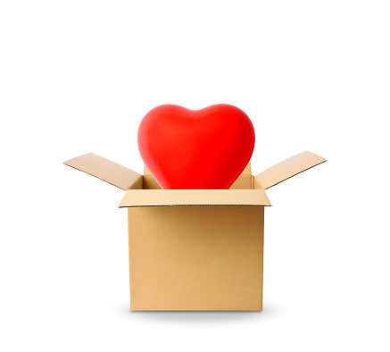 Close-up of red heart-shaped balloon floating from a cardboard box on white background.