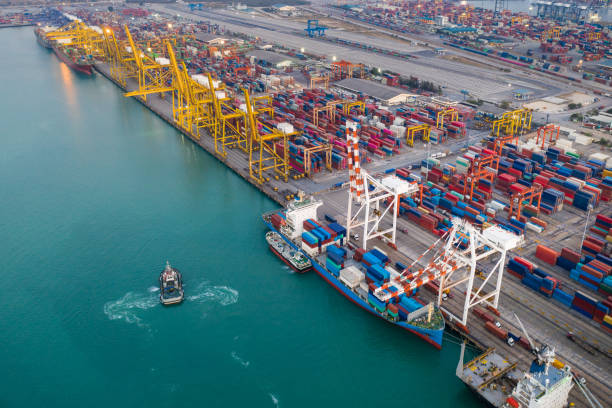 istock Containers ship and ports logistic freight load unloading by crane industry and business service shipping import export goods transportation of international by container ship large in ocean water worldwide photograph aerial top view from drone 1334949871