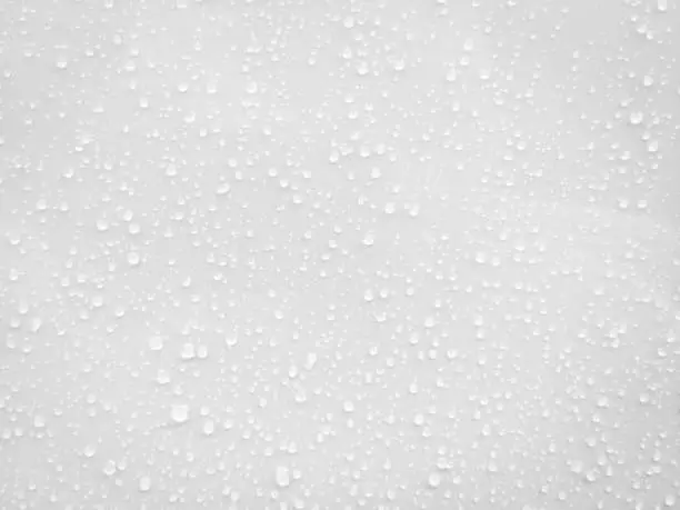 Photo of Water drops on white surface background.