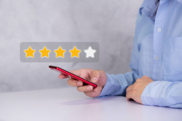Customer holding phone and pressing star icon for vote score review and feedback with quality and satisfaction, success of digital marketing with result excellent for ranking of service. Customer holding phone and pressing star icon for vote score review and feedback with quality and satisfaction, success of digital marketing with result excellent for ranking of service. goldco reviews personal stock pictures, royalty-free photos & images