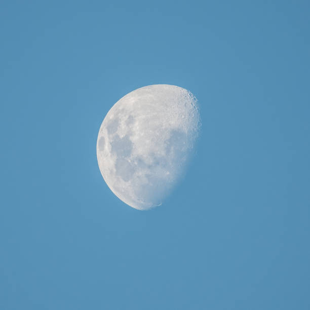 istock Late afternoon partial moon in the blue sky 1334957481