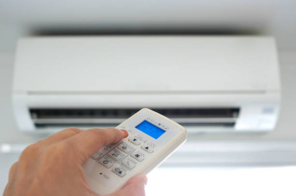 istock Man's hand using remote control open The air conditioner is cooled to 25 degrees Celsius in his bedroom. Health concepts and energy savings 1334962234