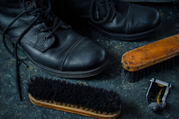 istock Old vintage leather boots with shoe brush 1334963366