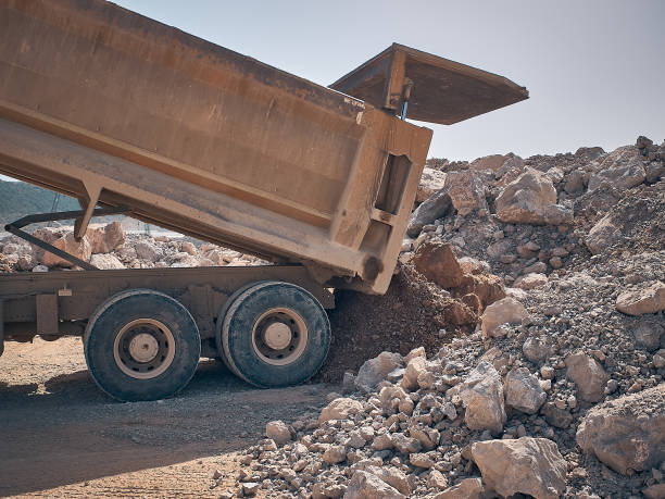 istock Dump truck unloads soil from truck back 1334963376
