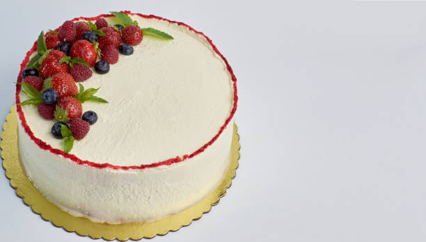 istock home made white cake with berries on isolated white background 1334964002