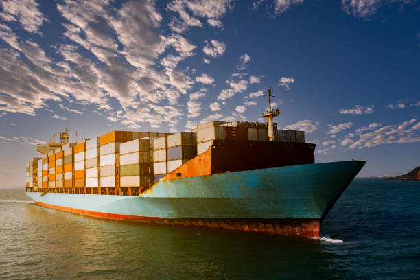 istock Aerial view container cargo ship carrying commercial container in import export business commerce logistic and transportation of international by container ship at morning over the sunlight blue sky background 1334964124