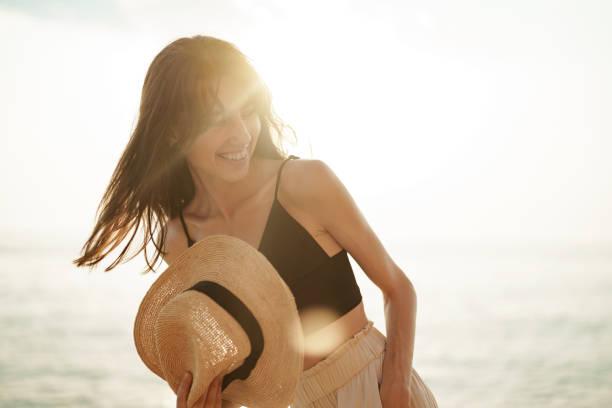 istock Young smiling woman outdoors portrait at beach 1334965855
