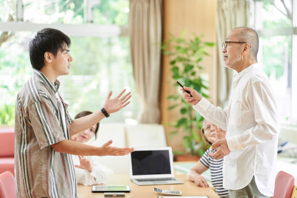 young couple and old couple quarreling - arguing senior adult conflict couple imagens e fotografias de stock