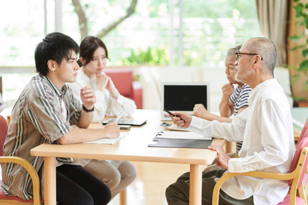 young couple and old couple quarreling - arguing senior adult conflict couple imagens e fotografias de stock