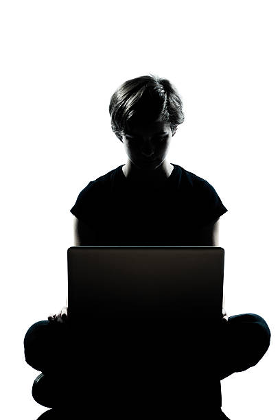 istock one young teenager boy or girl silhouette computer computing laptop 133496782