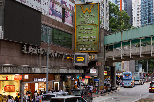 Hong Kong - August 18, 2021 : People walk past the Fortress Tower at King's Road, North Point, Hong Kong.